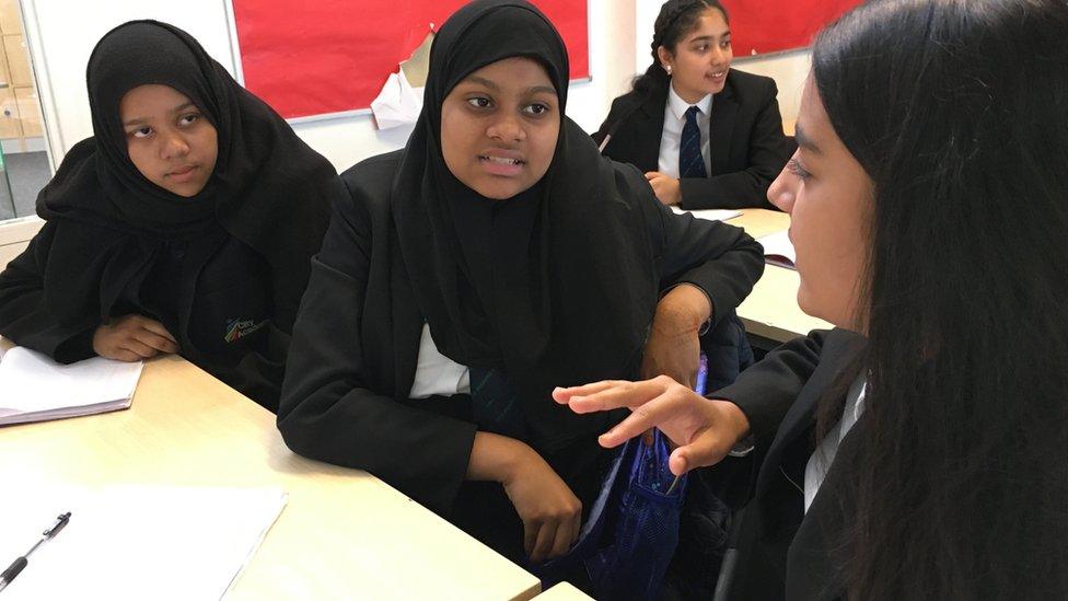 Image of Fatima, Saliha and Amina talking in class.