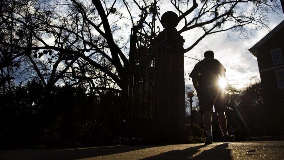 A man wears shorts and short sleeves at the University of Georgia campus in America where unseasonably warm temperatures have reached 21C