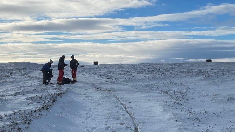 Team at the rescue site, with Claire on the ground