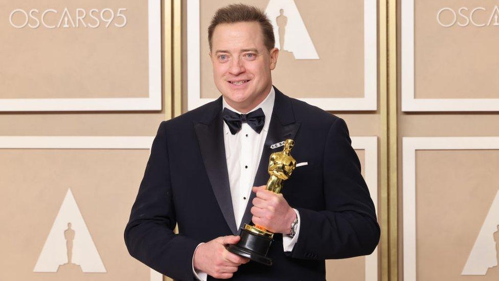 Brendan Fraser holding his Academy Award