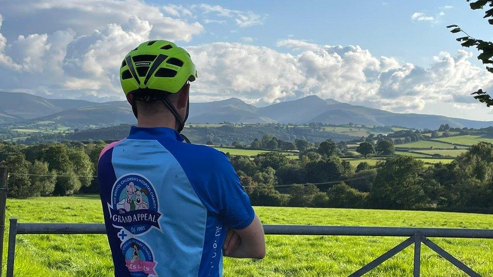 Jamie wearing a Grand Appeal shirt looking at landscape