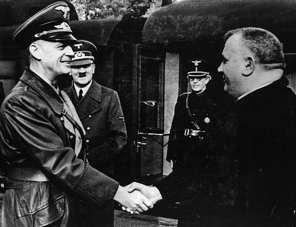 German Foreign Minister Joachim Von Ribbentrop greeting Jozef Tiso (R) as Adolf Hitler looks on