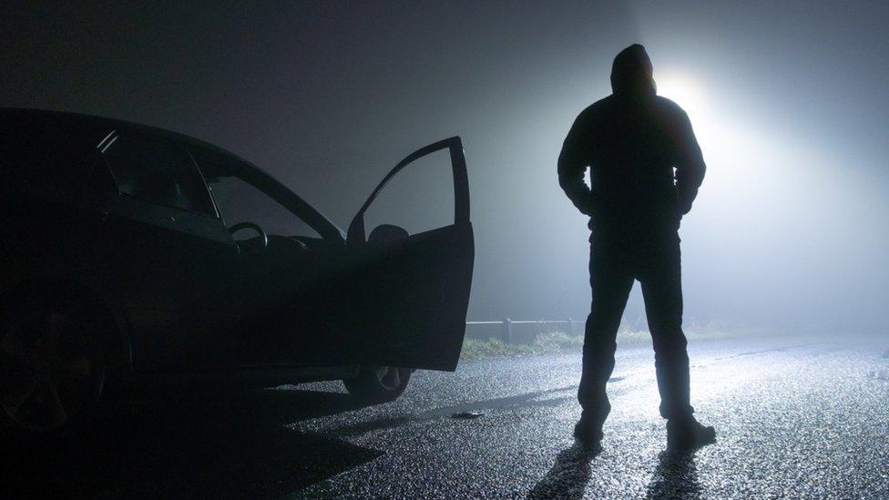 Shadowy man outside car