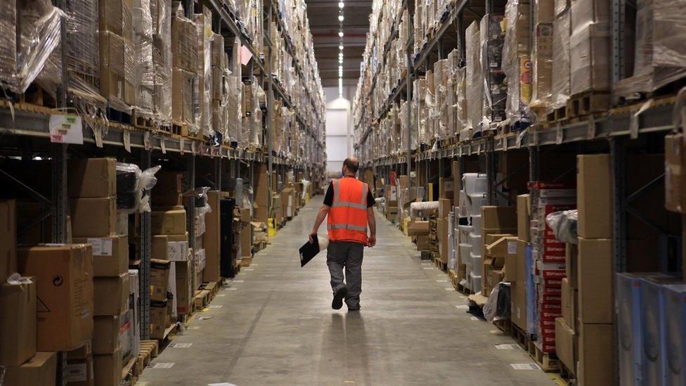 A worker walks through the Amazon facility in Swansea