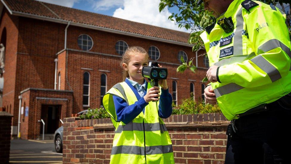 School girl using a speed camera