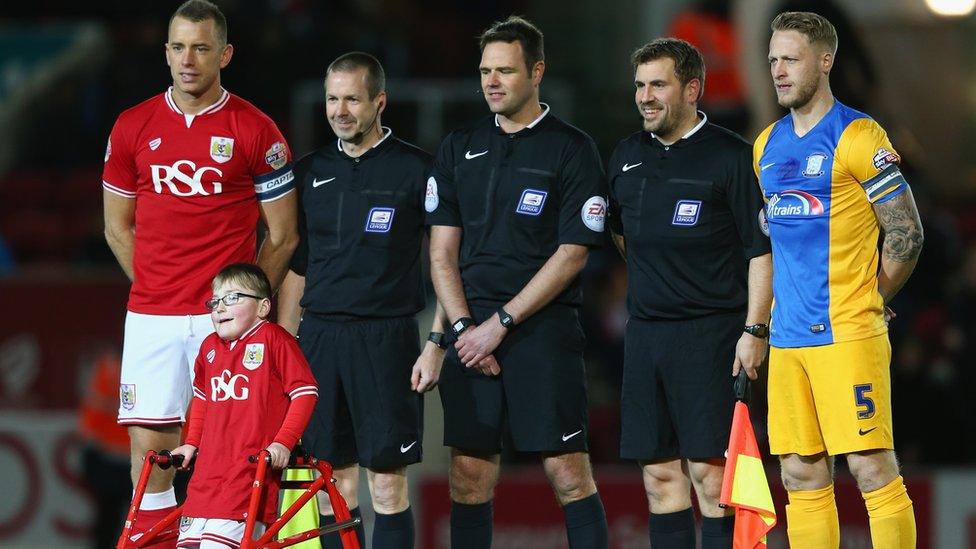 Oskar Pycroft alongside players and officials at Bristol City vs Preston North End