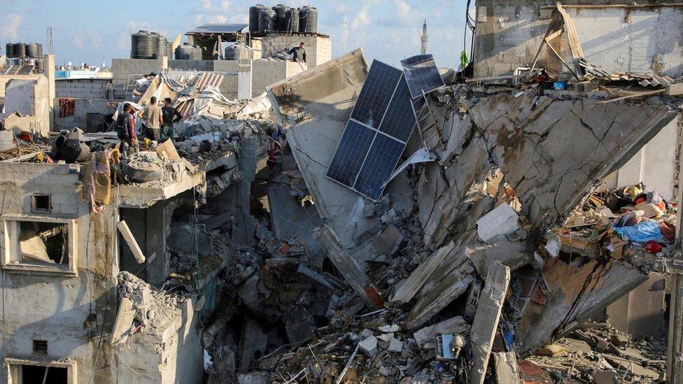 Palestinians inspect the site of an Israeli air strike in Rafah, in the southern Gaza Strip (7 May 2024)