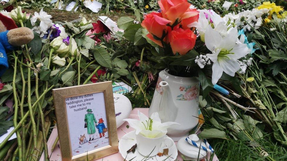 Eleanor's artwork left among floral tributes and a teapot