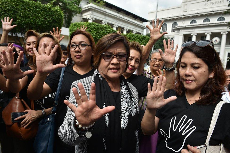 Former justice secretary and human rights chief Senator Leila de Lima (C) gestures with supporters after filing her petition for habeas data against Philippine President Rodrigo Duterte at the supreme court in Manila on 7 November 2016.