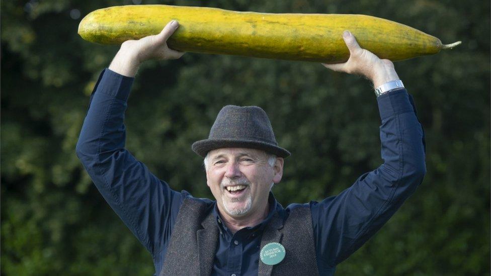 Graham Barratt with his winning giant cucumber that is 920mm long, after he scooped 1st prize