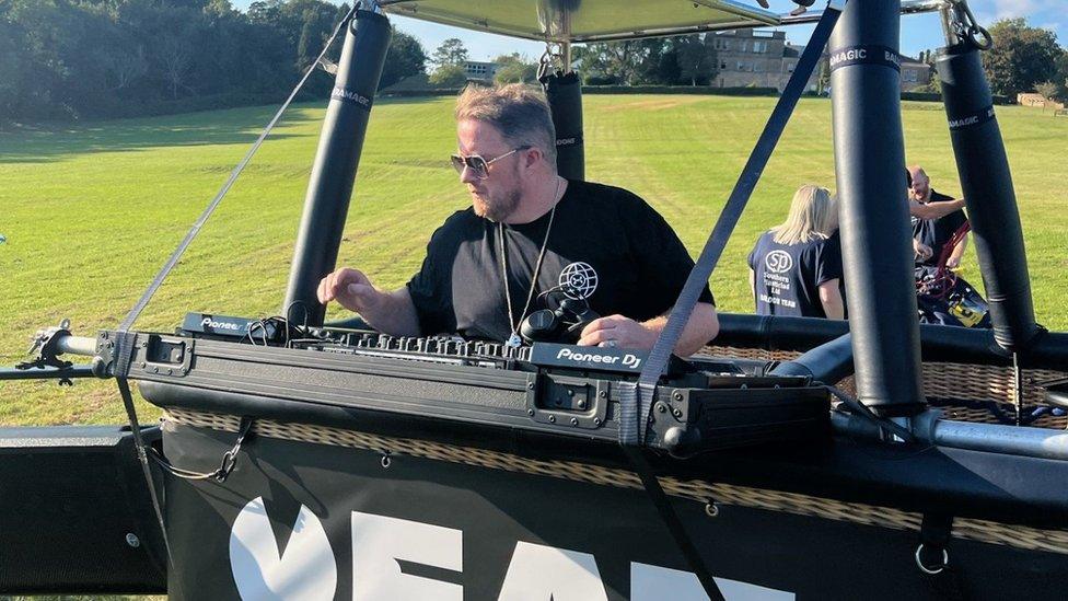 Eats Everything DJing on decks in the basket of a tethered hot air balloon