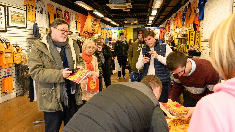 Fans buying copies