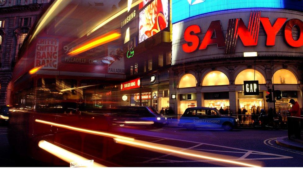 Bus travelling across Picadilly Circus at night