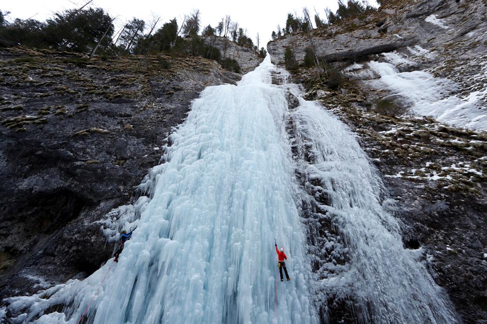 Italian alpine rescuers climb a frozen waterfall in Malga Ciapela, Italy, 11 February 2020