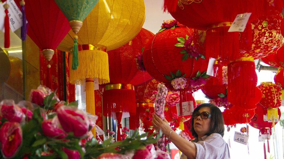 A woman checks out Lunar New Year decorations in Singapore