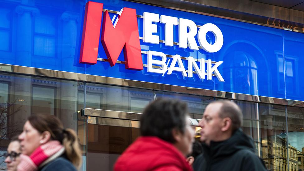 People walk outside a Metro Bank branch