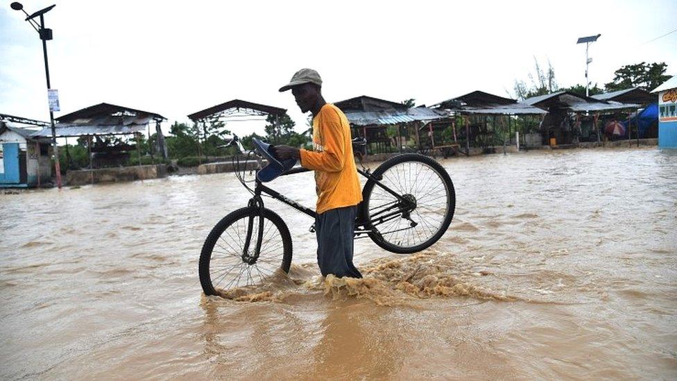 Crossing a flooded river near Port-au-Prince, Haiti, on 5 October 2016