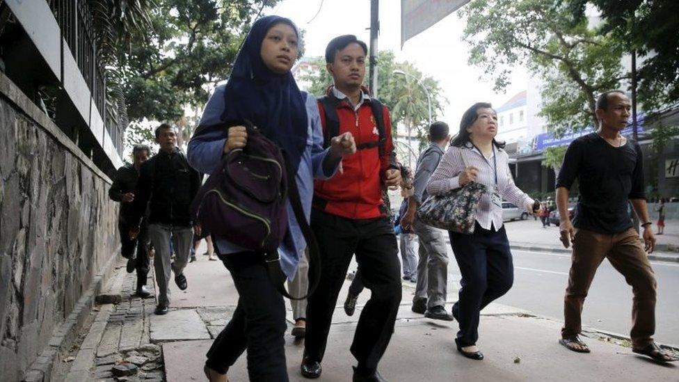 Indonesian workers run as they are evacuated from their office at Thamrin business district in Jakarta January 14, 2016.