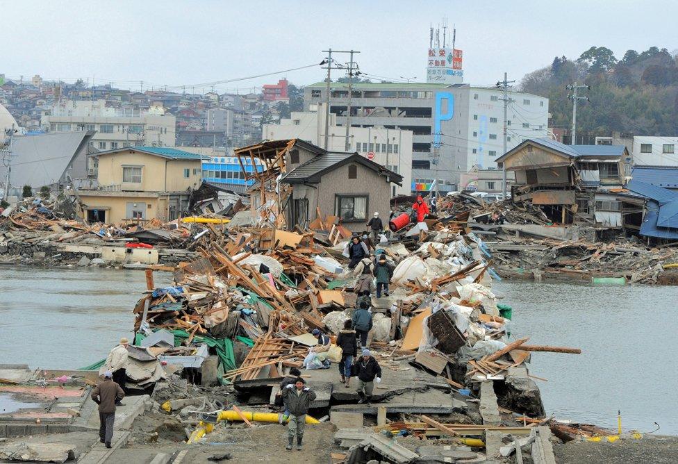 A bridge in Ishinomaki is covered in debris (Getty Images)