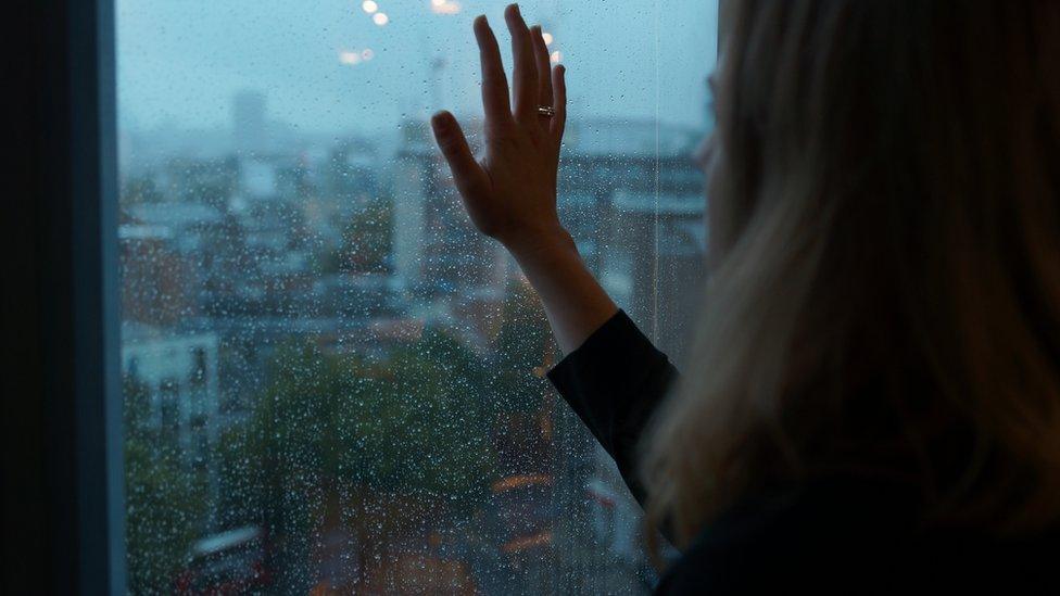 Woman looking out of a window