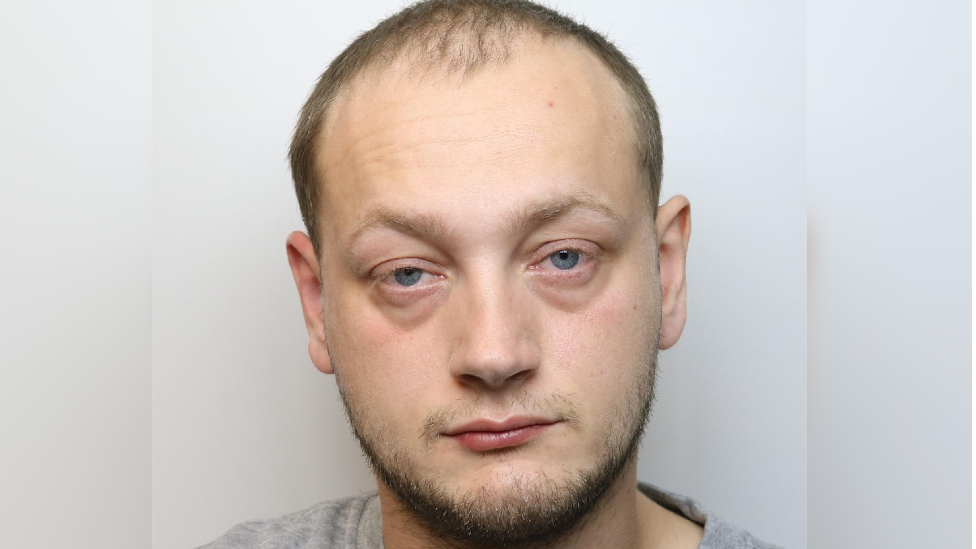 A police custody image of Reece Jolliffe. He has short dark hair and a small amount of facial hair. 