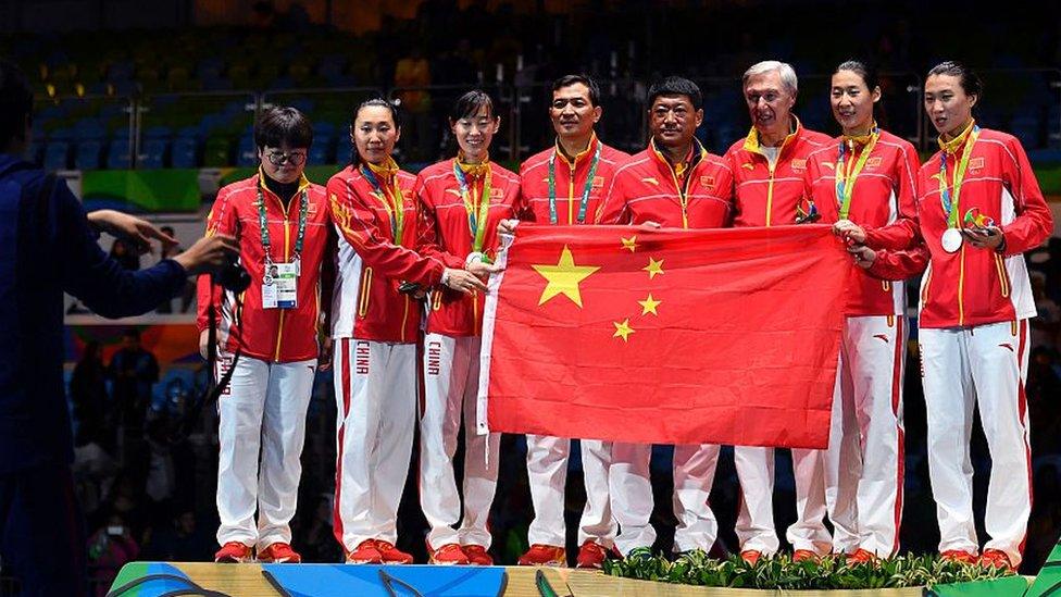 China's team celebrate their silver medal on the podium after the womens team epee fencing event of the Rio 2016 Olympic Games