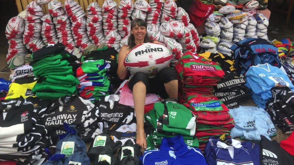 Mary Watkins in a pile of rugby kit