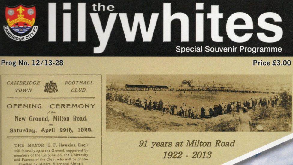 The close-up of the front cover of Cambridge City's souvenir programme for the last match at its Milton Road ground, focusing on the top half  showing a black and white image of the club's opening ceremony in 1922.  Written at its top is The Lilywhites. Taken from a souvenir programme from its last game at Milton Road in 2013