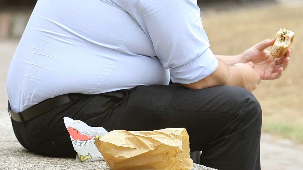 An overweight man eating