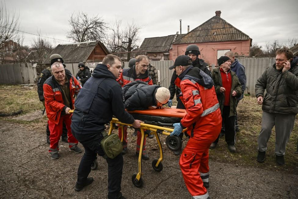 Paramedics evacuate an injured elderly woman after a cluster bomb strike in Kramatorsk