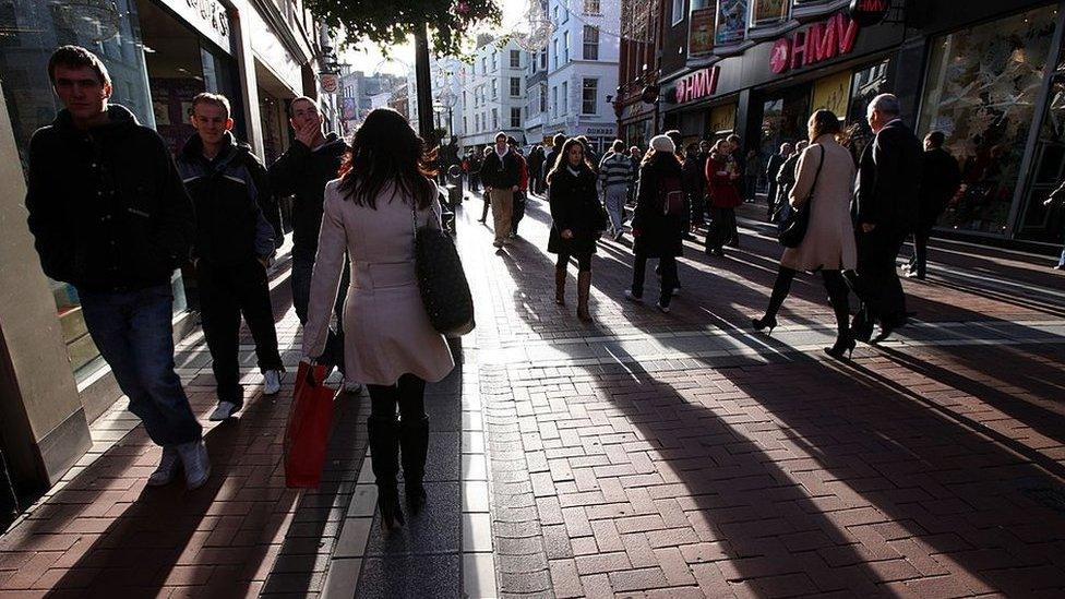 People walk along Grafton Street, the main shopping area of Dublin