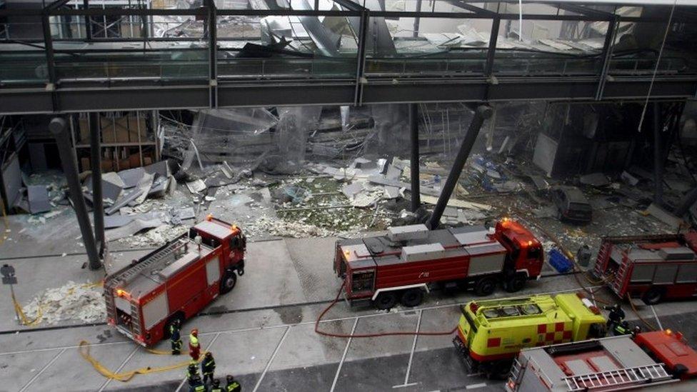 This file photo (taken on 30 December 2006) at Barajas Airport in Madrid shows firemen working inside the car park of Terminal 4, after a bomb exploded claimed by Basque separatist group Eta