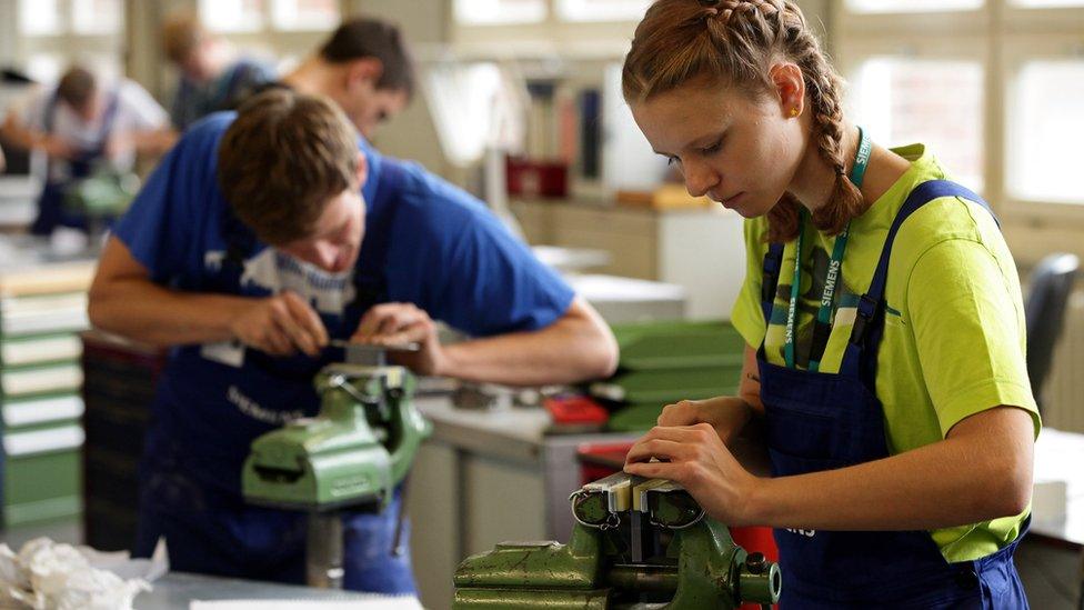 Apprentice engineers at their lathes