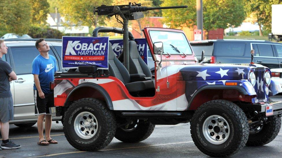 His campaign vehicle bore a machinegun and a Trump doll on the bonnet