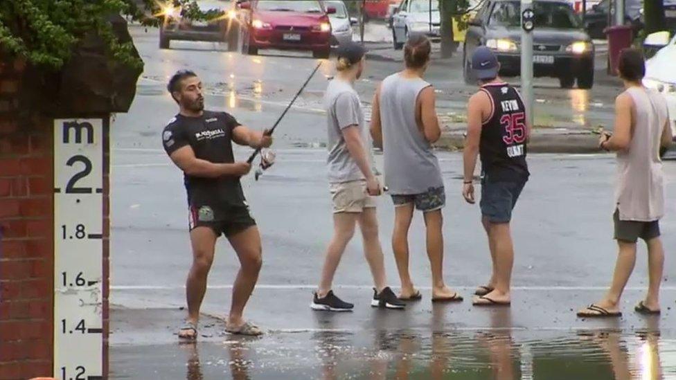 Mr Jordanou fishes in the floods