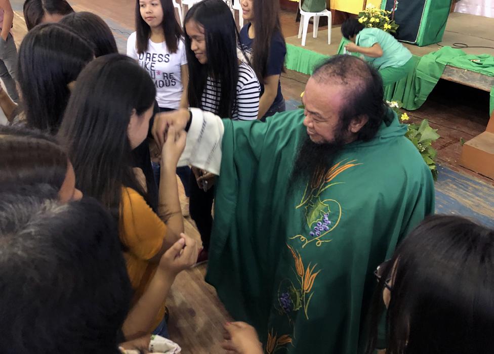 Father at Chito at church in university gymnasium