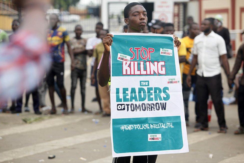 A boy holds a banner during a protest