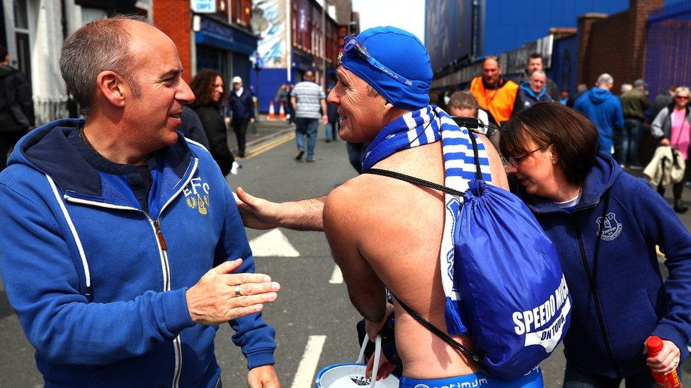 Michael Cullen, also known as Speedo Mick is greeted by a Everton fan outside the stadium