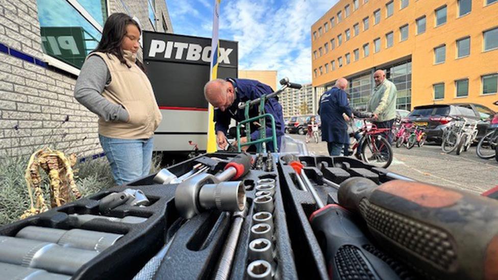 A volunteer working at the bike bank in Amsterdam