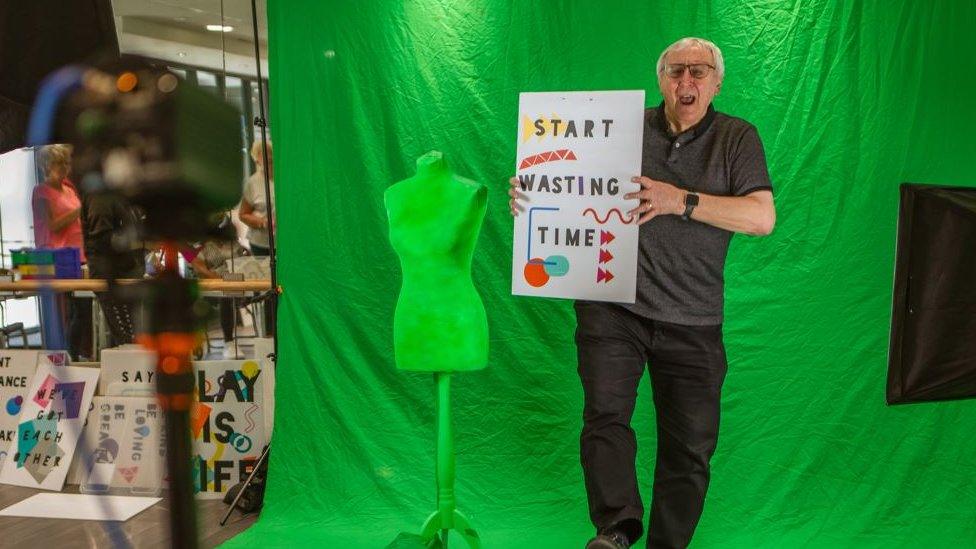 A man dancing in front of a green screen