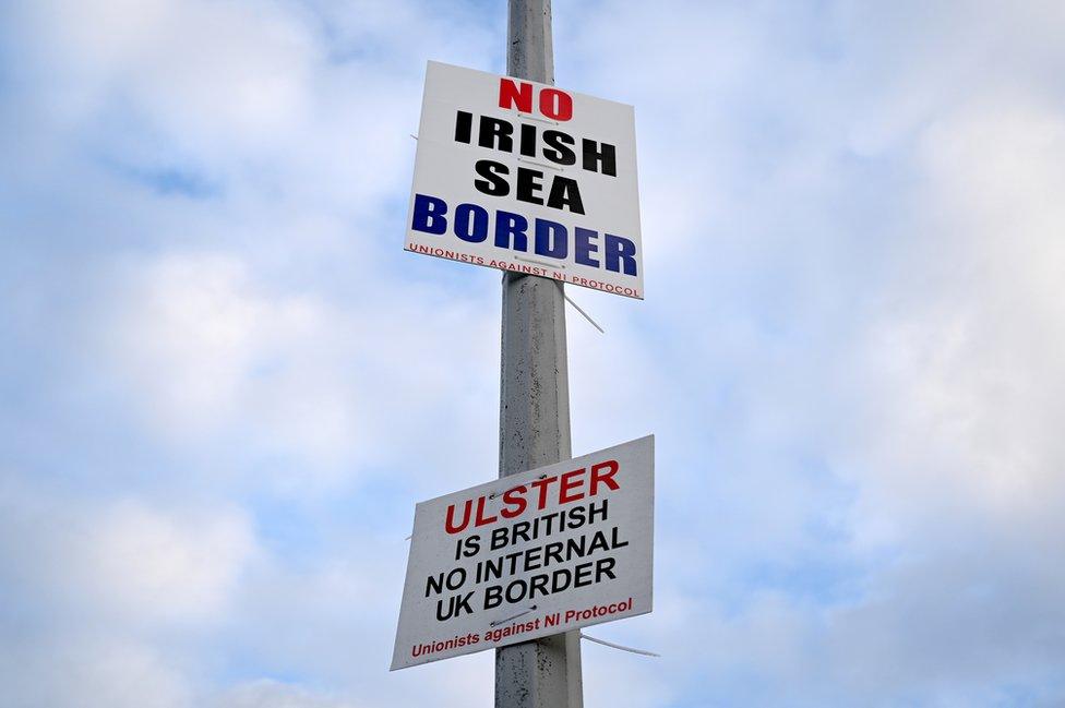 Placards on lampposts in Northern Ireland which read: No Irish Sea border - unionists against NI Protocol; Ulster is British - no internal UK border