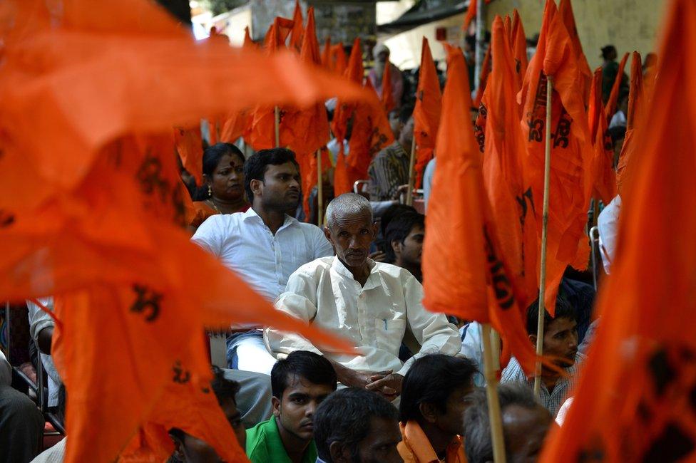 Right-wing groups waving saffron flags at a protest against alleged "love jhad"