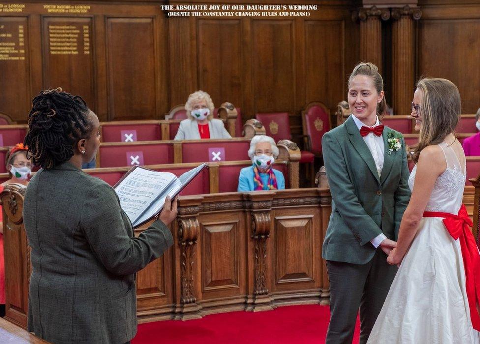 A wedding ceremony for two women and guests sitting socially distanced wearing facemasks.