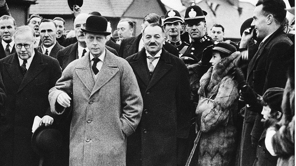 King Edward VIII walking in a crowd of people