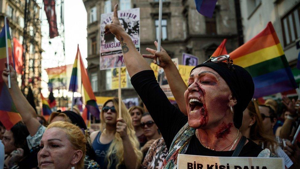 A LGBT member with make up on her face shouts slogans and gestures on August 21,2016 in Istanbul during a demonstration for the murdering of transgender activist Hande Kader