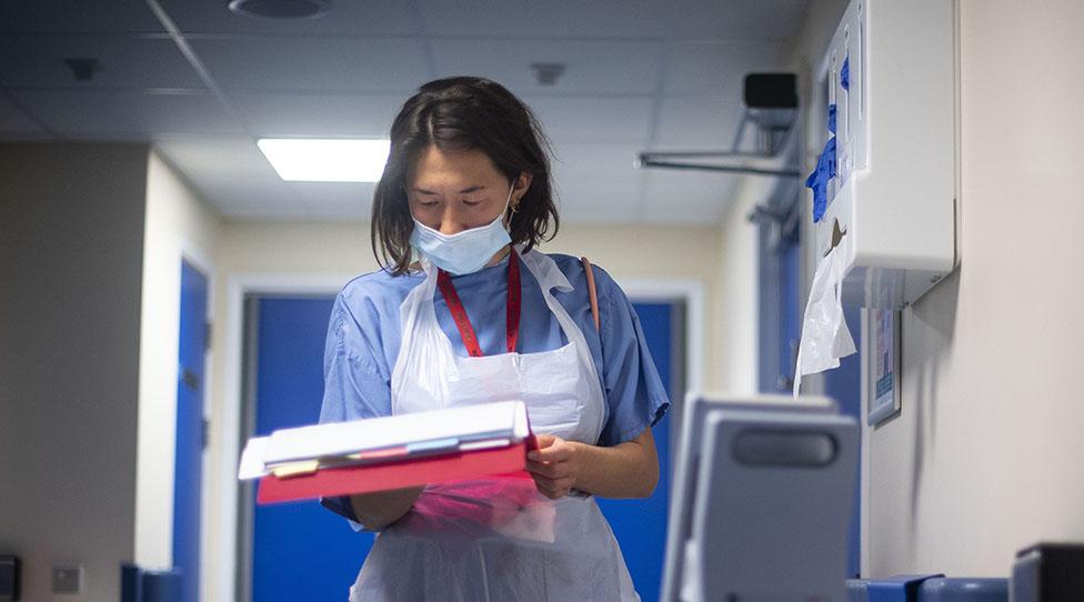 Hospital staff looking a notes