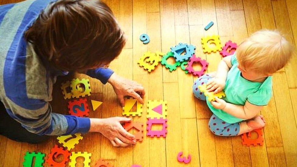 A grandparent plays with a young boy