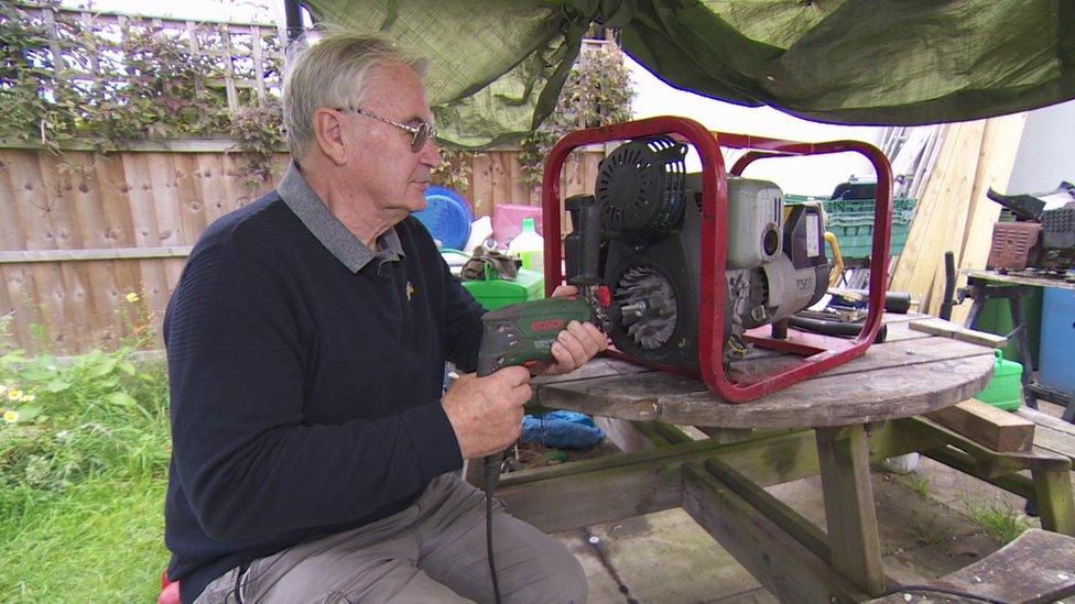 John Hardisty fixing a generator