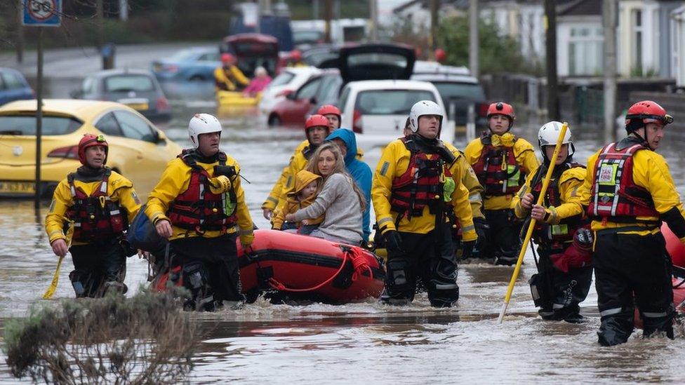 A family is rescued from floodwater in Nantgarw by boat