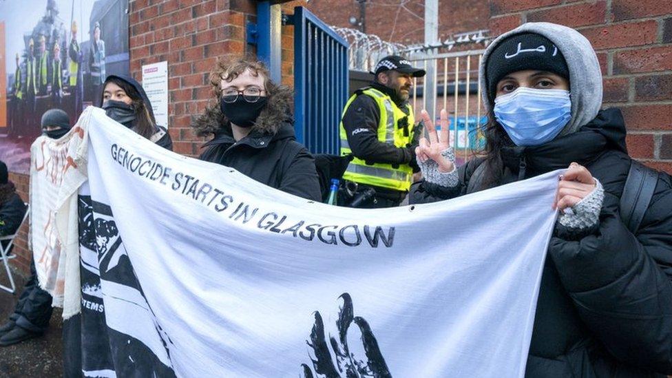 Bint (not her real name) holding a banner with other protesters